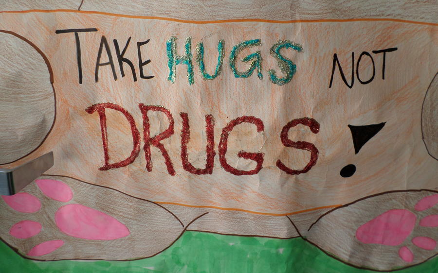 Student artwork text reads: take hugs not drugs